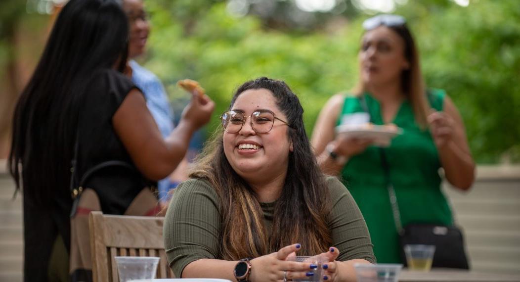 A smiling student sitting at a table